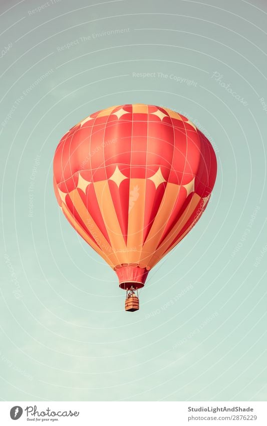 Orange hot air balloon in the sky Joy Leisure and hobbies Vacation & Travel Adventure Freedom Sports Sky Transport Aircraft Hot Air Balloon Old Flying Faded