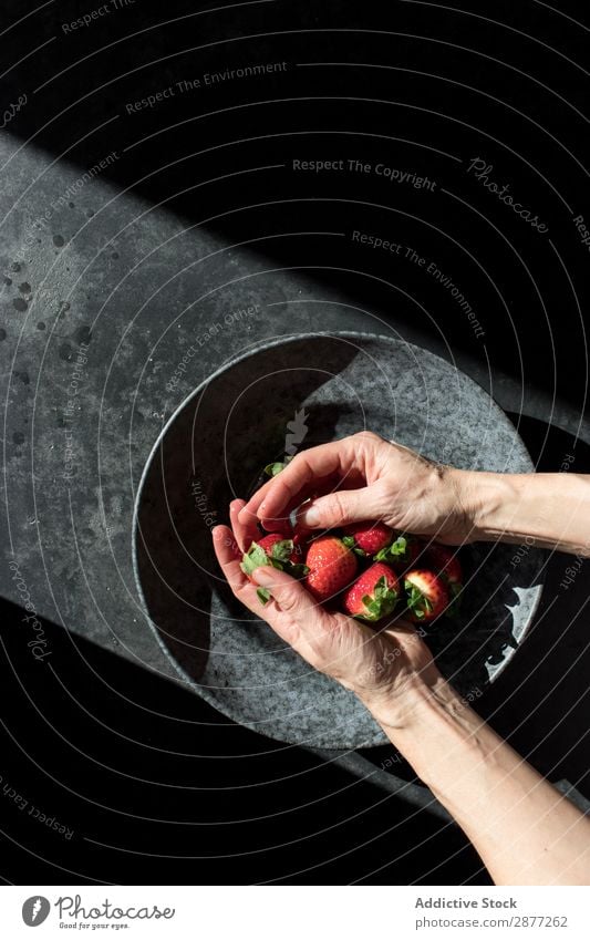 Hands with heap of strawberry near plate Strawberry Plate Heap Fresh Accumulation Bowl Sunbeam darkness Illuminate Fruit Food Sweet Red Dessert Healthy