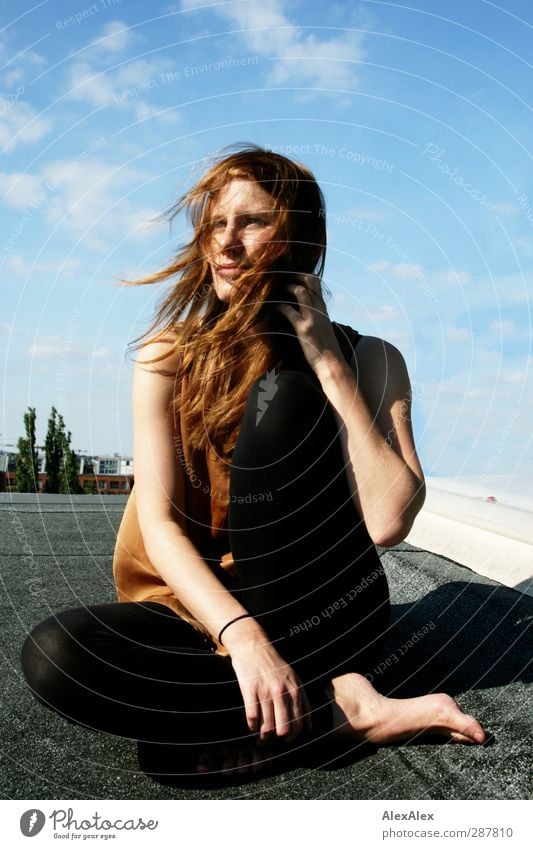 long-legged, redheaded model on a roof on a sunny, windy day Young woman Youth (Young adults) Body 18 - 30 years Adults Model Barefoot Red-haired Long-haired