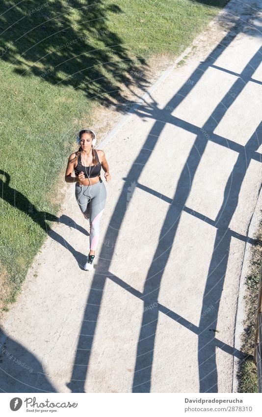 beautiful young Woman running jogging in a park outdoors listening music Jogging Running Fitness Stretching Practice Girl Youth (Young adults)