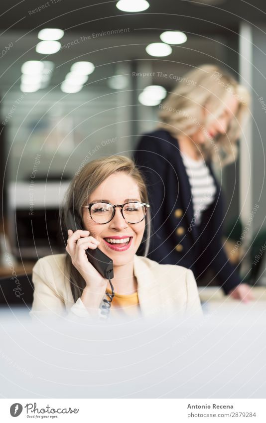 Secretary working Elegant Desk Work and employment Workplace Office Business Company Telephone Human being Woman Adults Suit Smiling To call someone (telephone)