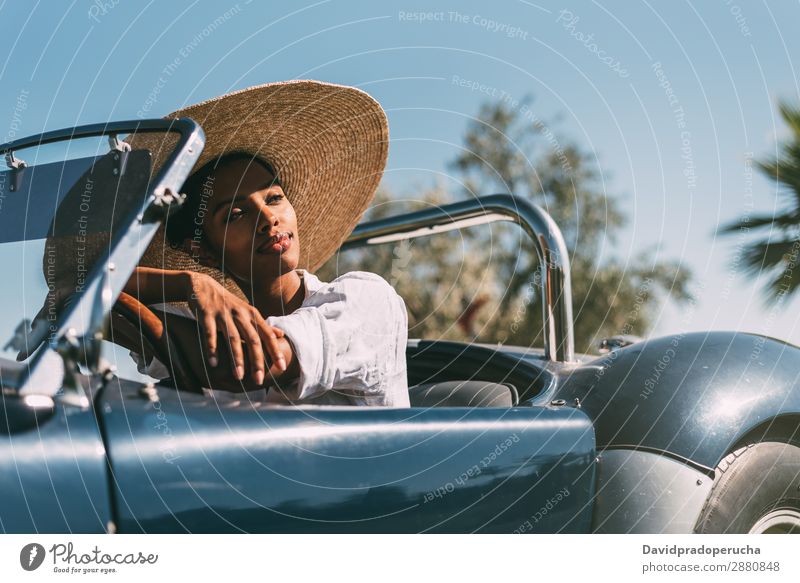 Black woman driving a vintage convertible car Woman Car Driving Ethnic Happy Convertible Street Luxury Looking away Smiling Classic 60's Beautiful cabriolet