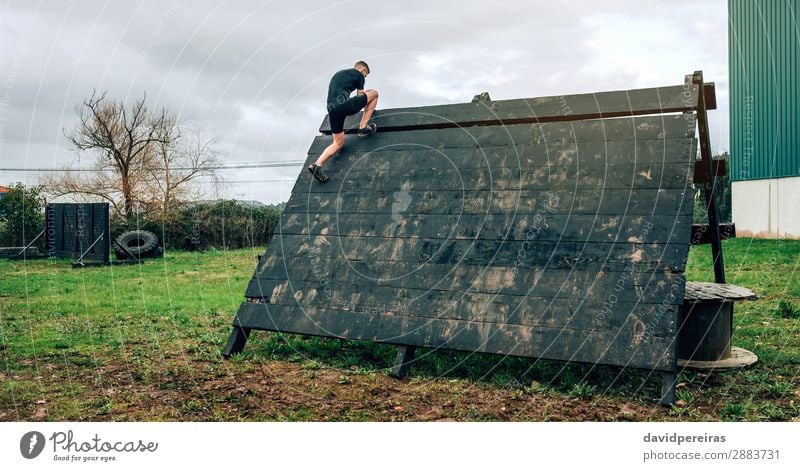 Man participant in obstacle course climbing pyramid Sports Climbing Mountaineering Human being Adults Authentic Strong Loneliness Effort Competition