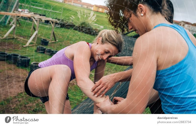 Participants in obstacle course climbing pyramid Sports Climbing Mountaineering Human being Woman Adults Group Authentic Strong Effort Competition Teamwork