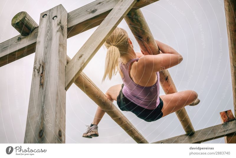 Woman in obstacle course doing weaver obstacle Lifestyle Sports Human being Adults Blonde Wood Authentic Above Strong Power Effort Competition