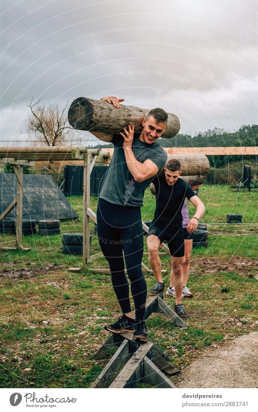 Participants in obstacle course carrying trunks Joy Happy Contentment Sports Human being Woman Adults Man Group Fitness Smiling Carrying Authentic Strong Power