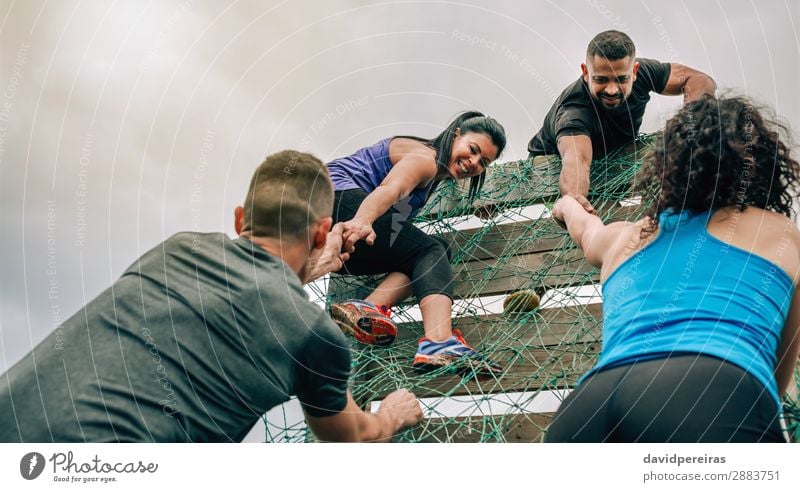 Participants in obstacle course climbing net Lifestyle Sports Climbing Mountaineering Human being Woman Adults Man Group Authentic Strong Effort Competition