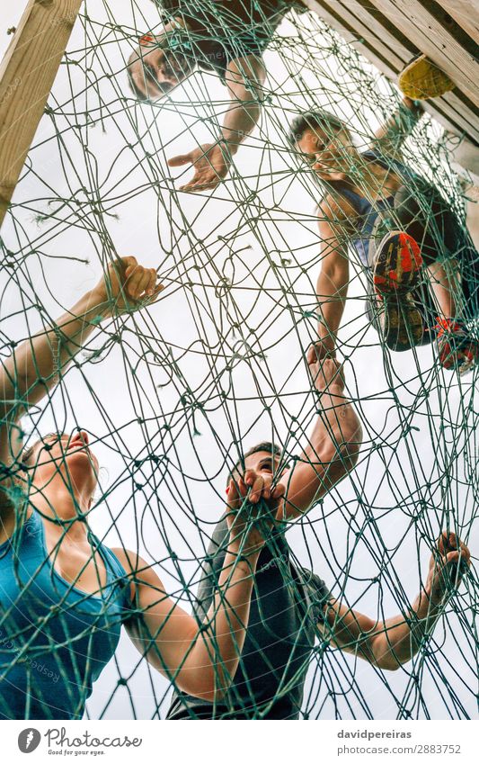 Participants in obstacle course climbing net Lifestyle Sports Climbing Mountaineering Human being Woman Adults Man Group Smiling Authentic Strong Effort