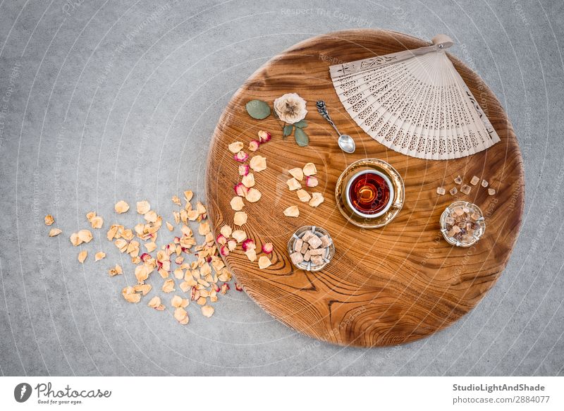 Vintage wooden table with tea and rose petals Dessert Candy Beverage Tea Plate Spoon Design Table Flower Concrete Wood Metal Natural Retro Brown Yellow Gold