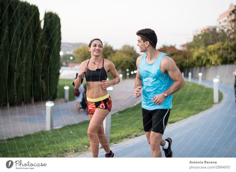 Couple running in city park Flirt Sports Human being Woman Adults Man 18 - 30 years Youth (Young adults) Brunette Fitness Running Together Beautiful Strong jog