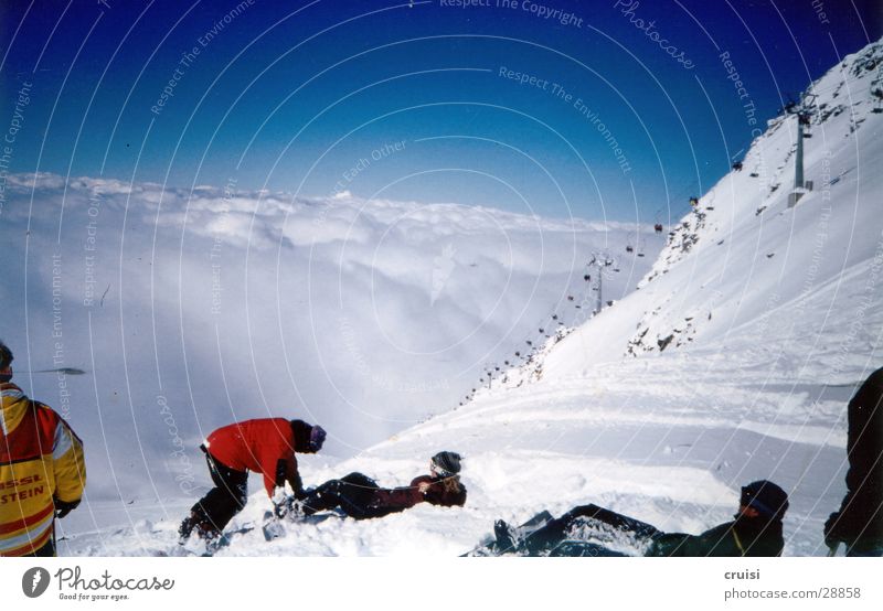 above the clouds Clouds Chair lift Virgin snow Winter vacation Tux Sports Sky Snow Sun Powder snow Snowboarder Break Above the clouds Steep Group Vantage point