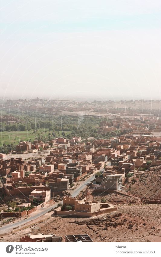 dusty desert city I Summer Desert Oasis Village Small Town Hot Dry Africa Morocco Dust Sahara dust road Clay brick houses Mud hut Colour photo Exterior shot Day