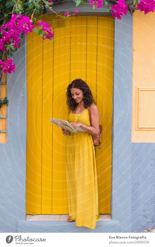 Young tourist woman in yellow dress looking a map Happy Vacation & Travel Tourism Trip Sightseeing Telephone Human being Feminine Young woman