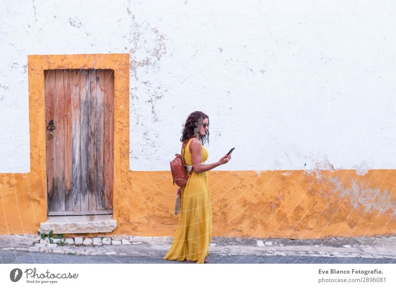 Young woman in yellow dress walking by the city Happy Vacation & Travel Tourism Trip Sightseeing Telephone Human being Feminine Youth (Young adults) Woman