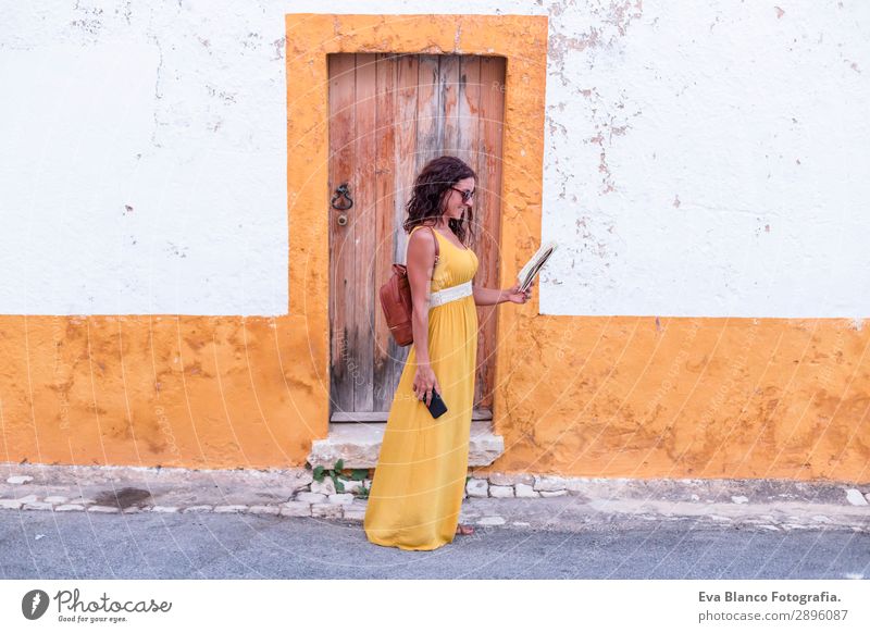 Young woman in yellow dress walking by the city Happy Vacation & Travel Tourism Trip Sightseeing Telephone Human being Feminine Youth (Young adults) Woman