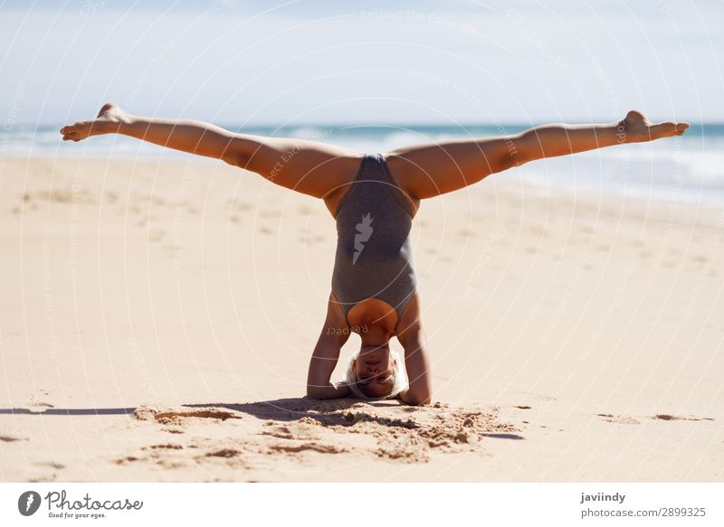 Caucasian blonde woman practicing yoga in the beach Lifestyle Beautiful Body Harmonious Relaxation Meditation Summer Beach Ocean Sports Yoga Human being