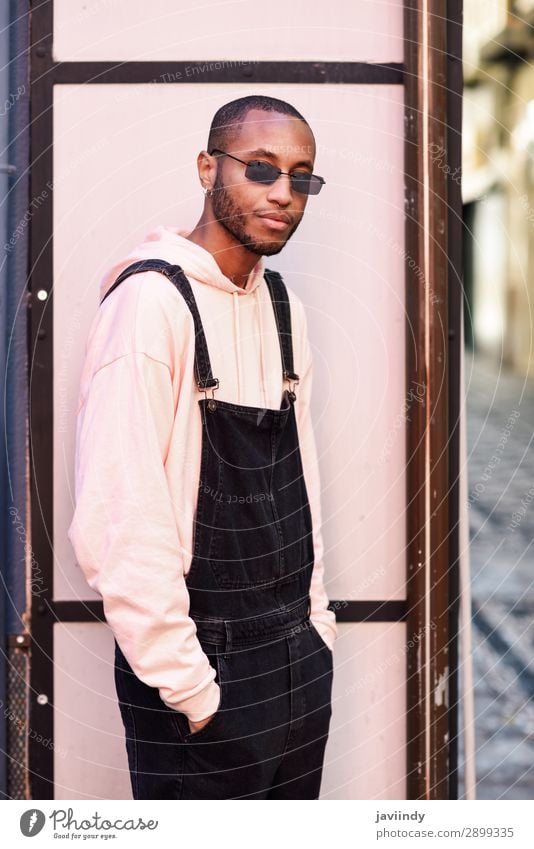 African guy with bib pants standing outdoors Lifestyle Beautiful Human being Masculine Young man Youth (Young adults) Man Adults 1 18 - 30 years Street Fashion