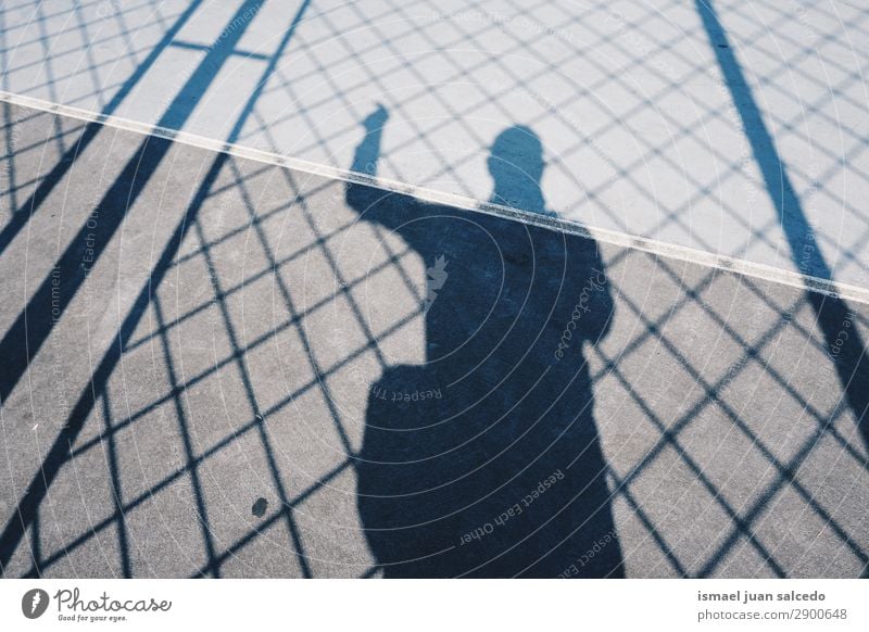 boy shadow silhouetete on the ground Silhouette Human being Man Boy (child) Shadow Light (Natural Phenomenon) Sun Street Fence Ground Exterior shot City