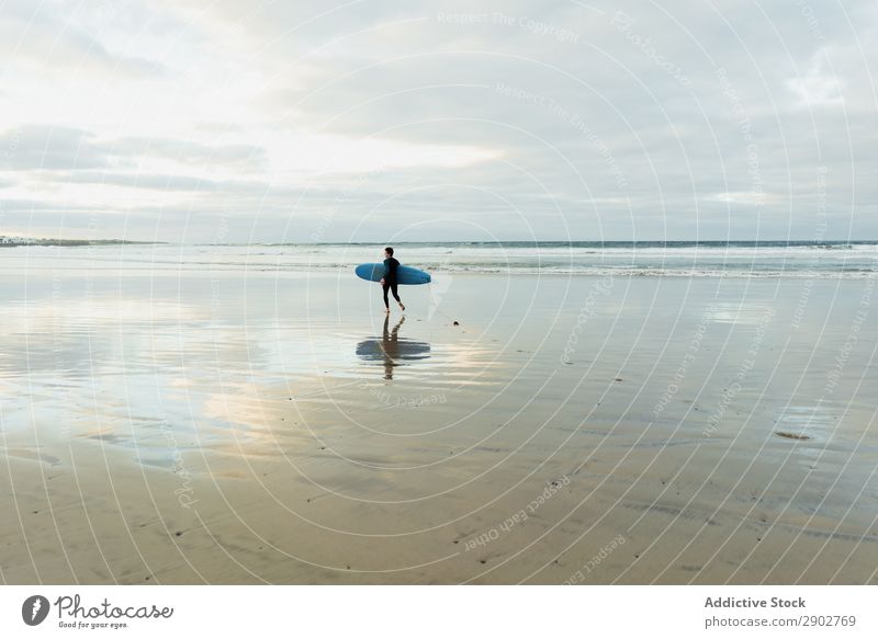 Person with surfboard walking near sea Human being Surfboard Ocean Sand Wet Walking Clouds Sky Lanzarote Spain Vacation & Travel Trip Leisure and hobbies