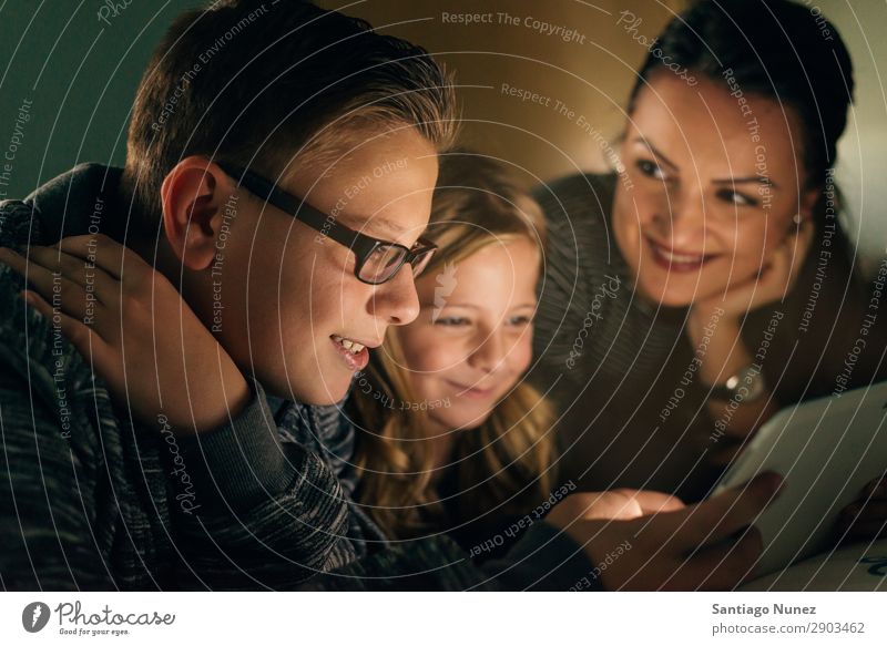 Mother and her children with digital tablet relaxing at home. Family Concept. Tablet computer Child Smiling Computer Playing Girl Boy (child) Family & Relations