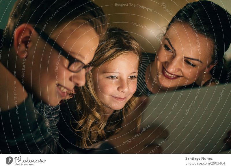 Mother and her children with digital tablet. Tablet computer Child Smiling Computer Playing Girl Boy (child) Family & Relations Education Small Daughter Son