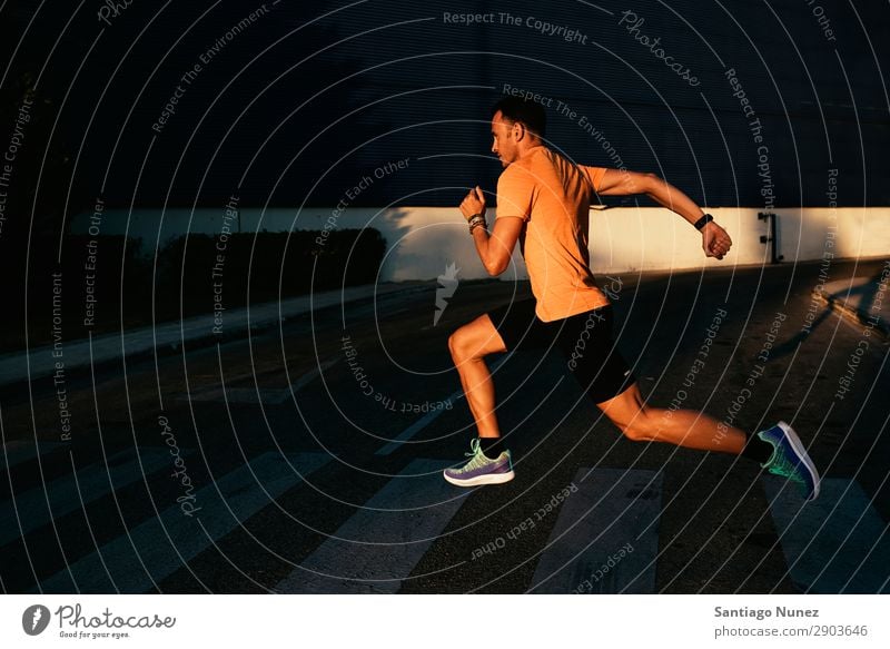 Handsome man running in the city. Man Running Jogging Runner Street City Athlete Speed Fitness Lifestyle Youth (Young adults) Town Action Shadow Healthy Sports