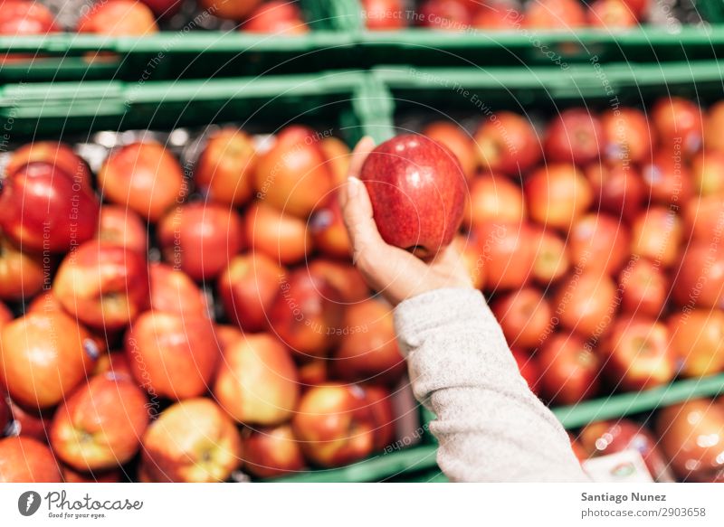 Beautiful woman choosing apples in supermarket. Fruit Supermarket Woman Close-up Storage Human being Apple Markets Food Hand Healthy Fresh Hold Shopping