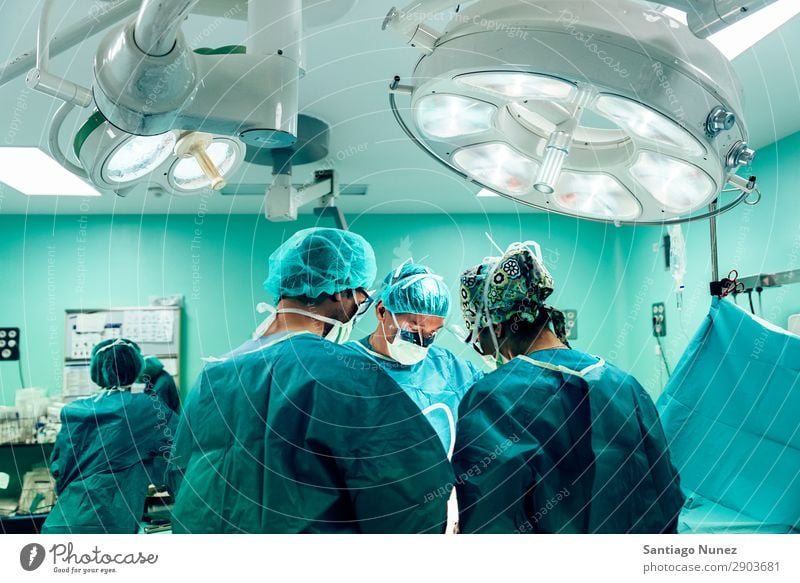 Team of Surgeons Operating in the Hospital. Operation Surgery operating surgical Room Doctor Theatre Medication Work and employment Group instrumental clinic