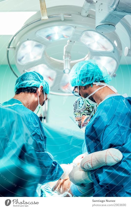 Team of Surgeons Operating in the Hospital. Operation Surgery operating surgical Room Doctor Theatre Medication Work and employment Group instrumental clinic