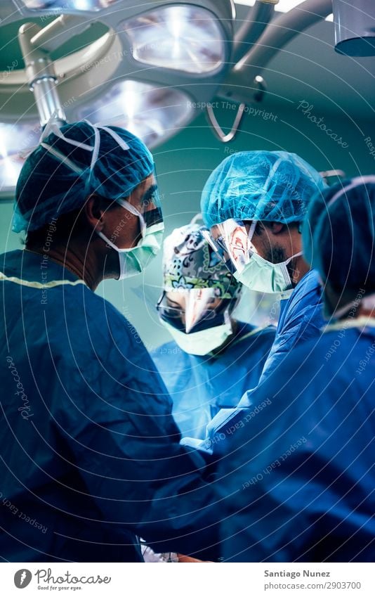 Team of Surgeons Operating. Operation Surgery operating surgical Hospital Room Doctor Theatre Medication Work and employment Group instrumental clinic Man Woman