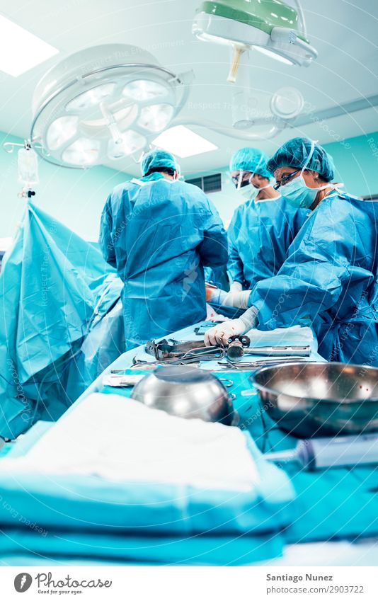 Team of Surgeons Operating. Operation Surgery operating surgical Hospital Room Doctor Theatre Medication Work and employment Group instrumental clinic Man Woman