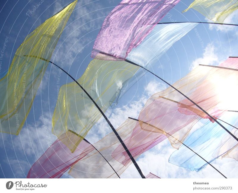 Flags in the wind Environment Landscape Air Sky Clouds Sun Beach North Sea Blue Multicoloured Yellow Wind Sky blue Flagpole Colour photo Exterior shot Deserted