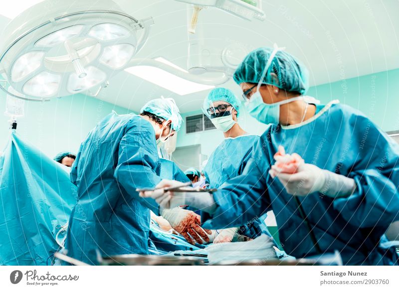 Team of Surgeons Operating. Operation Surgery operating surgical Hospital Room Doctor Theatre Medication Work and employment Group instrumental clinic Man Woman