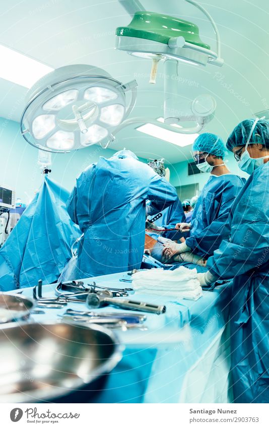 Team of Surgeons Operating Operation Surgery operating surgical Hospital Room Doctor Theatre Medication Work and employment Group instrumental clinic Man Woman