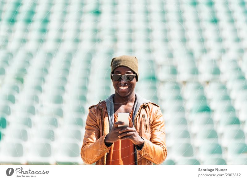 American man using mobile. Man Telephone Cellphone Town African Black Mobile Youth (Young adults) Laughter PDA Technology Human being Happy Happiness Smiling