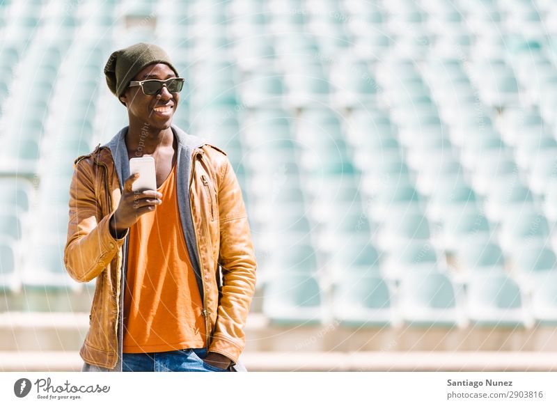 American man using mobile. Man Telephone Cellphone Town African Black Mobile Youth (Young adults) Laughter PDA Technology Human being Happy Happiness Smiling