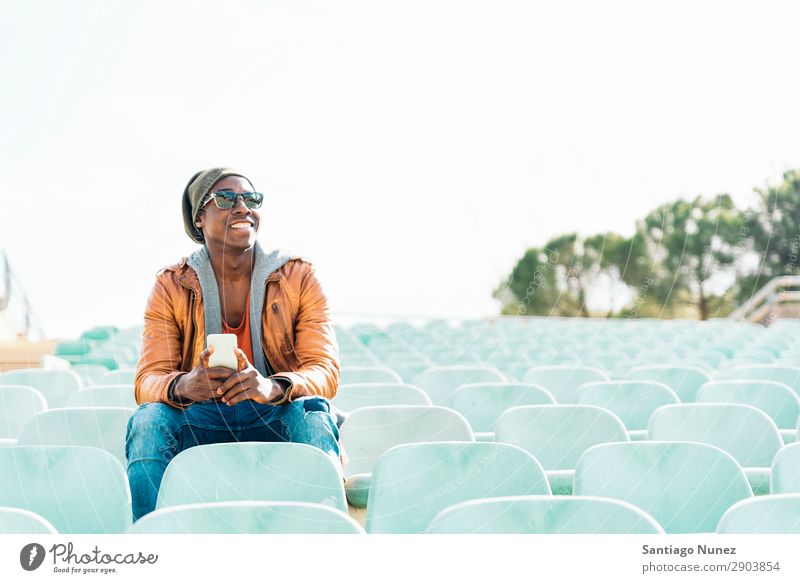 American man using mobile. Man Telephone Cellphone Town African Black Mobile Youth (Young adults) Laughter PDA Technology Human being Happy Happiness Smiling