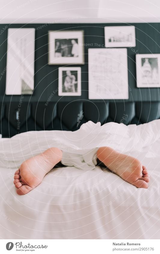 A bed with two feet coming out of the sheets Lifestyle Happy Skin Relaxation Vacation & Travel Bedroom Human being Adults Hand Fingers Feet Love Sleep White