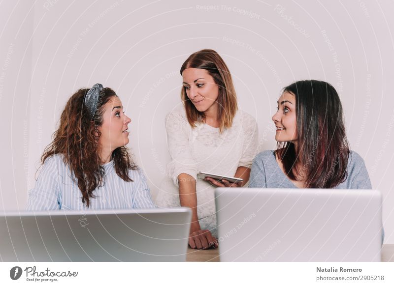 Three women working together in the office Happy Desk Work and employment Profession Workplace Office Business To talk Computer Notebook Technology Woman Adults