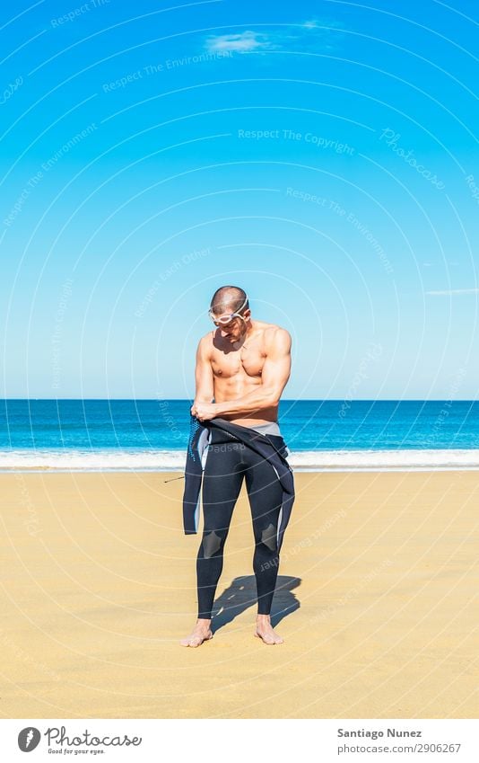 Handsome swimmer preparing to start swimming Attractive Beach Black Caucasian Diver Practice Athletic Fitness Person wearing glasses Skiing goggles handsome