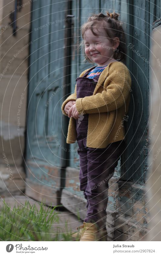 Girls eyes wink gate Feminine Toddler 1 Human being 1 - 3 years Grass Königsberg Gate Door Cardigan Overalls Boots Brunette Short-haired Bangs Chignon Small