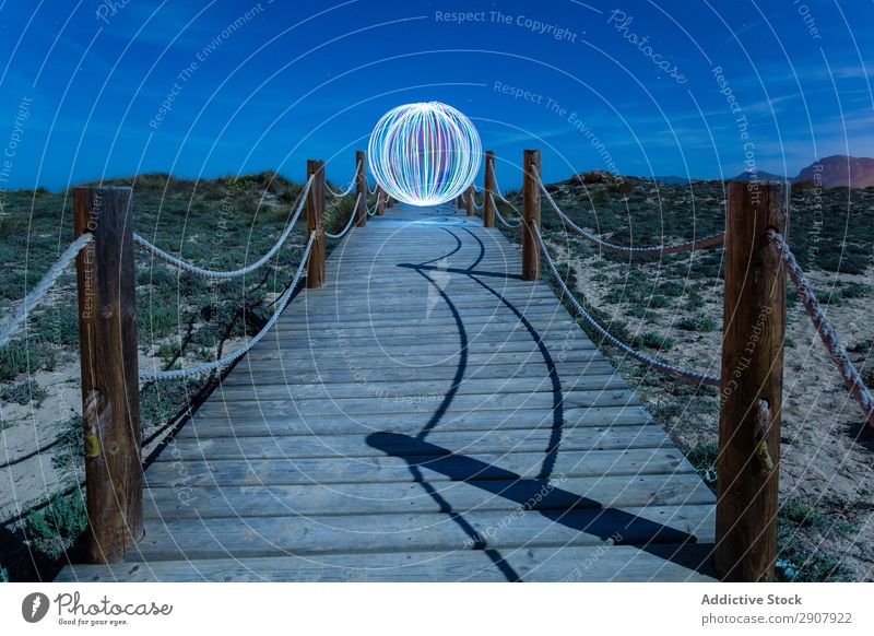 Abstract ball on footbridge between lands Ball levitating Footbridge Landing Sphere Red Ground Hill Sky Heaven Blue Evening Design Construction way Tourism