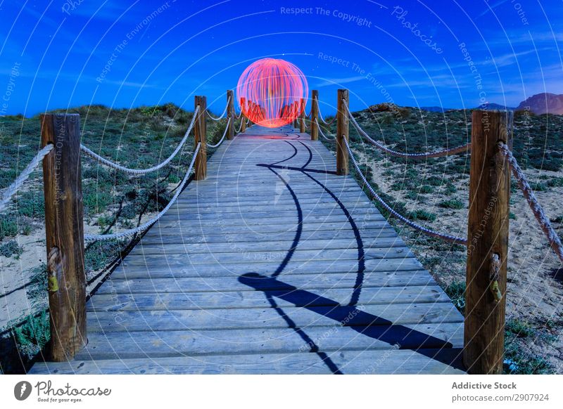 Abstract ball on footbridge between lands Ball levitating Footbridge Landing Sphere Red Ground Hill Sky Heaven Blue Evening Design Construction way Tourism