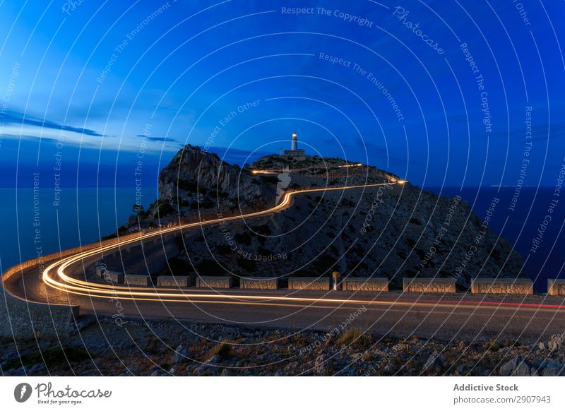 long exposure road at night with a light house in hill Speed Red Light Transport Long Movement Street Exposure Night Scene way Colour Vacation & Travel