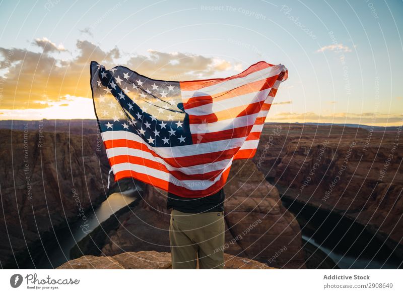 Anonymous male with USA flag near canyon Man Flag waving Canyon River Vacation & Travel Sky Sunset West Coast Cliff Adventure Nature Symbols and metaphors