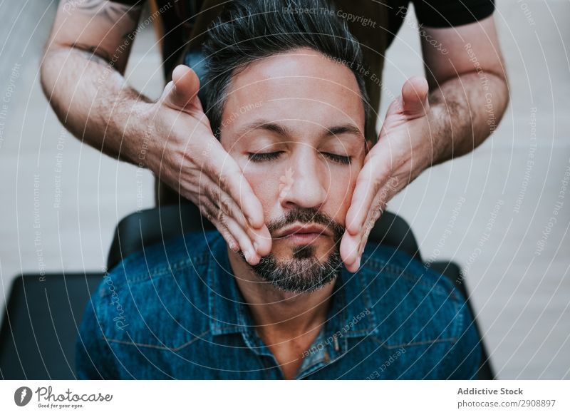 Barber doing face massage to handsome male Man Face Massage Style Closed eyes Professional Sit Chair Medical treatment Healthy Therapy Adults Wellness