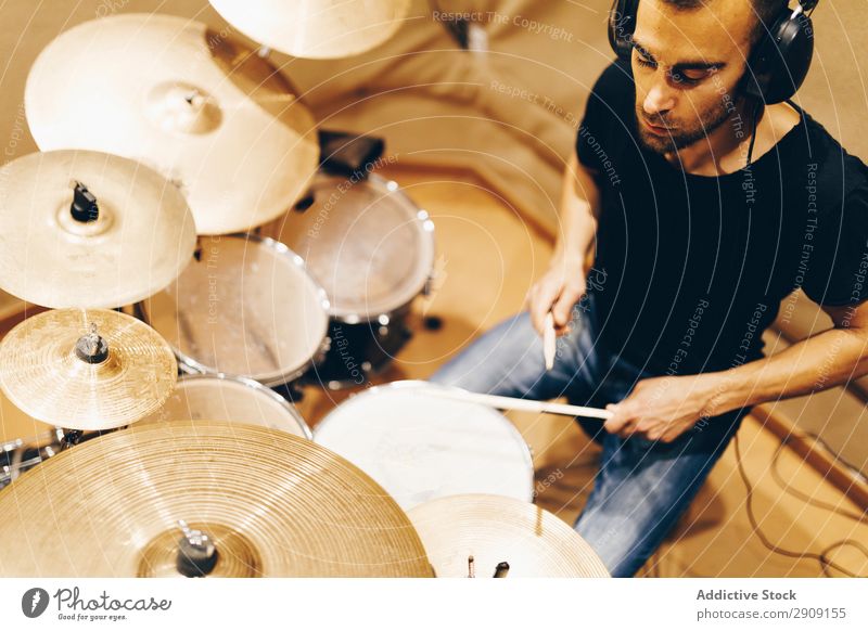 Man with headphones playing on drums Headphones Drum Playing Positive handsome Studio shot Music Professional Youth (Young adults) Drummer Equipment device