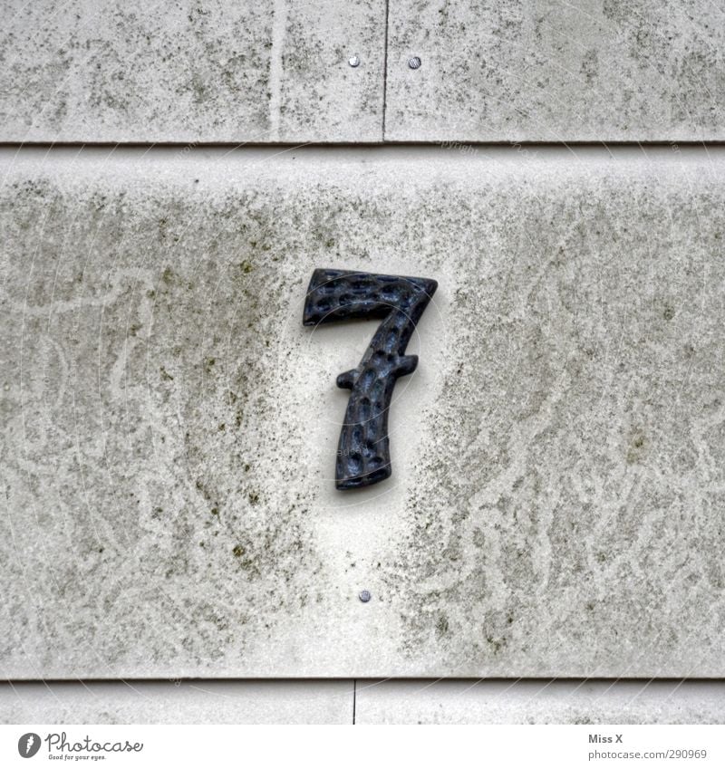 7 Sign Characters Signs and labeling Old Dirty Gray House (Residential Structure) House number Wall (building) Colour photo Subdued colour Exterior shot