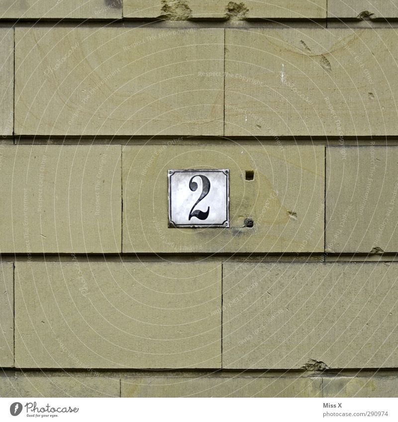 2 Sign Characters Old House number Stone wall Wall (building) House (Residential Structure) Signs and labeling Hollow Colour photo Exterior shot Close-up