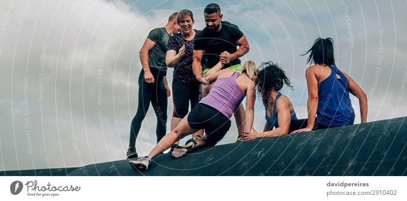 Participants in obstacle course climbing drum Happy Feasts & Celebrations Sports Climbing Mountaineering Internet Human being Woman Adults Man Group Smiling